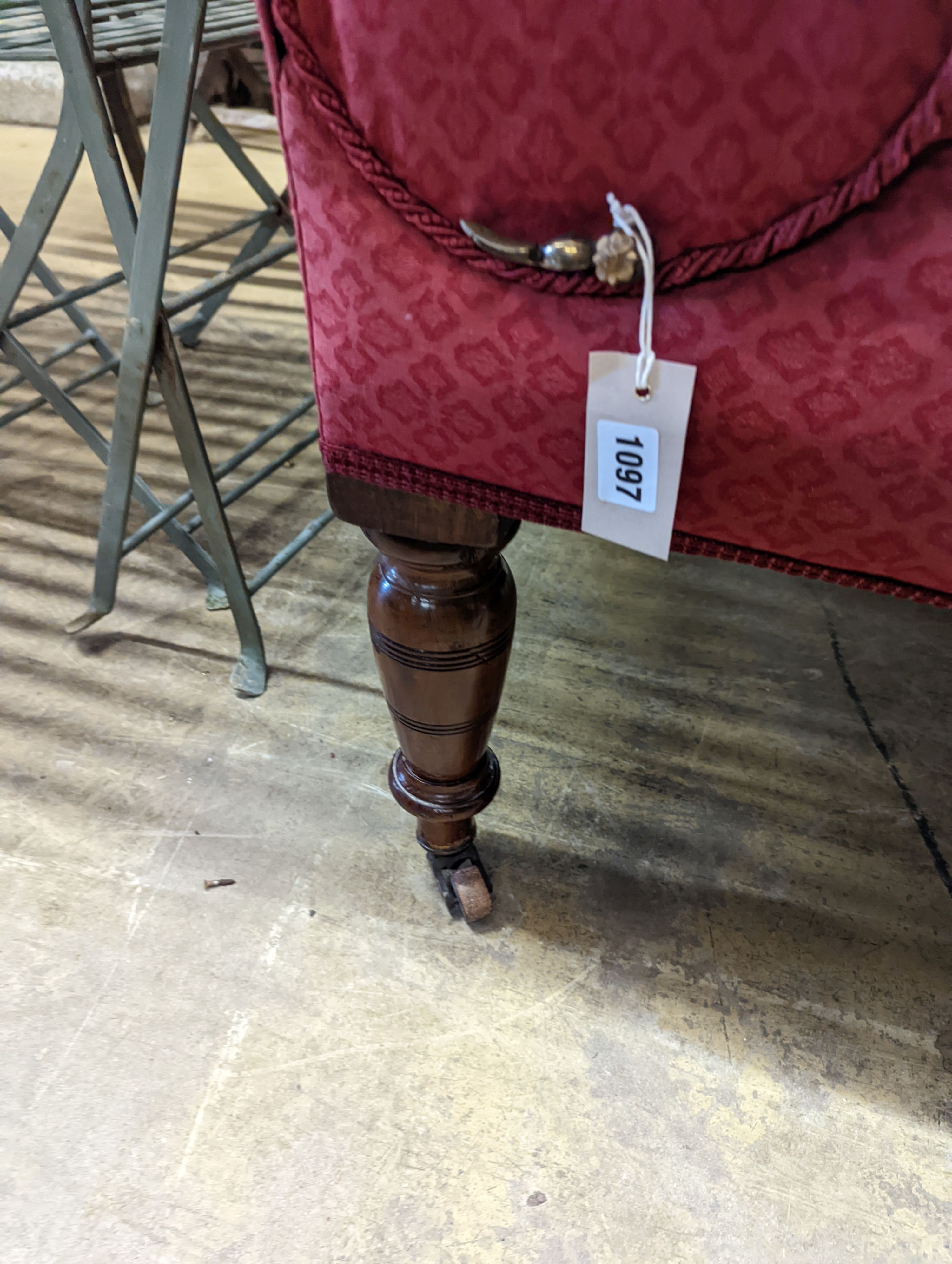 A Victorian mahogany drop arm daybed upholstered in buttoned red fabric, length 160cm, depth 70cm, height 96cm